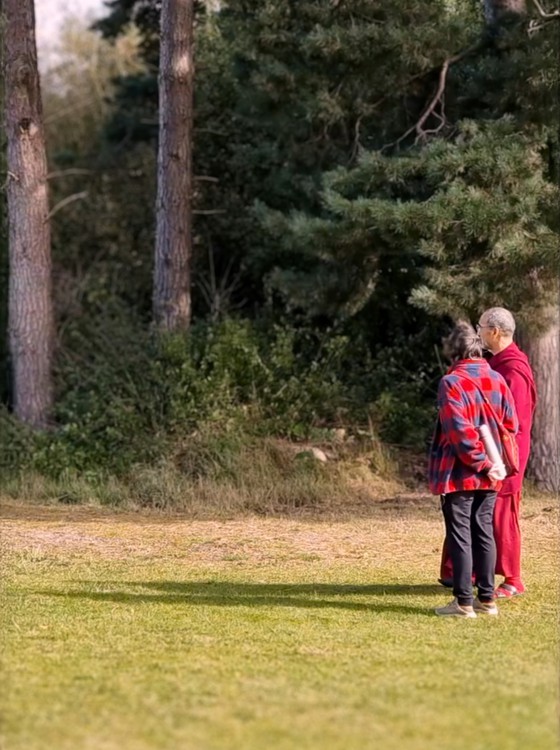 Lama Tenzin in the green fields at Buddhist Centre UK in Doncaster