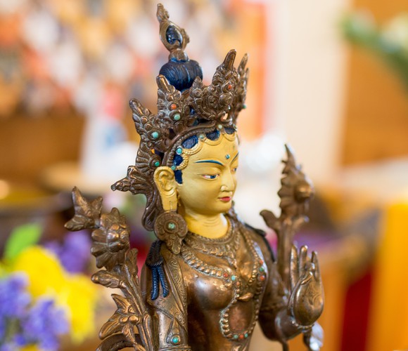 Golden statue of Tara, Buddhist deity of compassion in action.